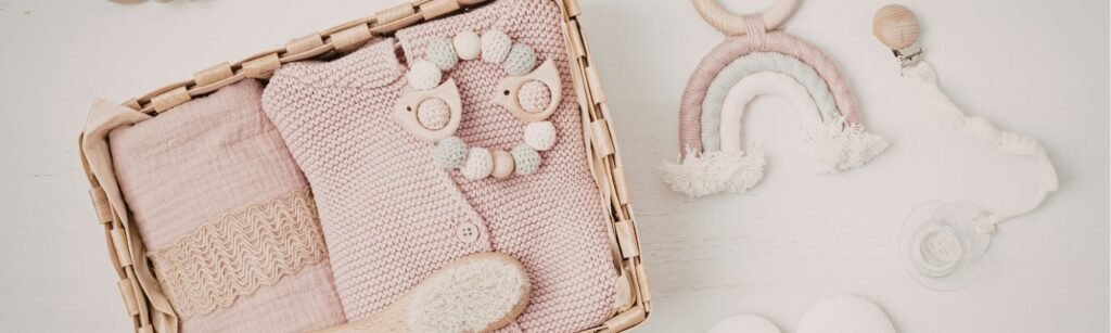 Top view of 7 carefully selected baby essentials for new mothers, including high-quality apparel, feeding accessories, and eco-friendly toys arranged in a clean, modern layout. Practical guide for newborn preparation