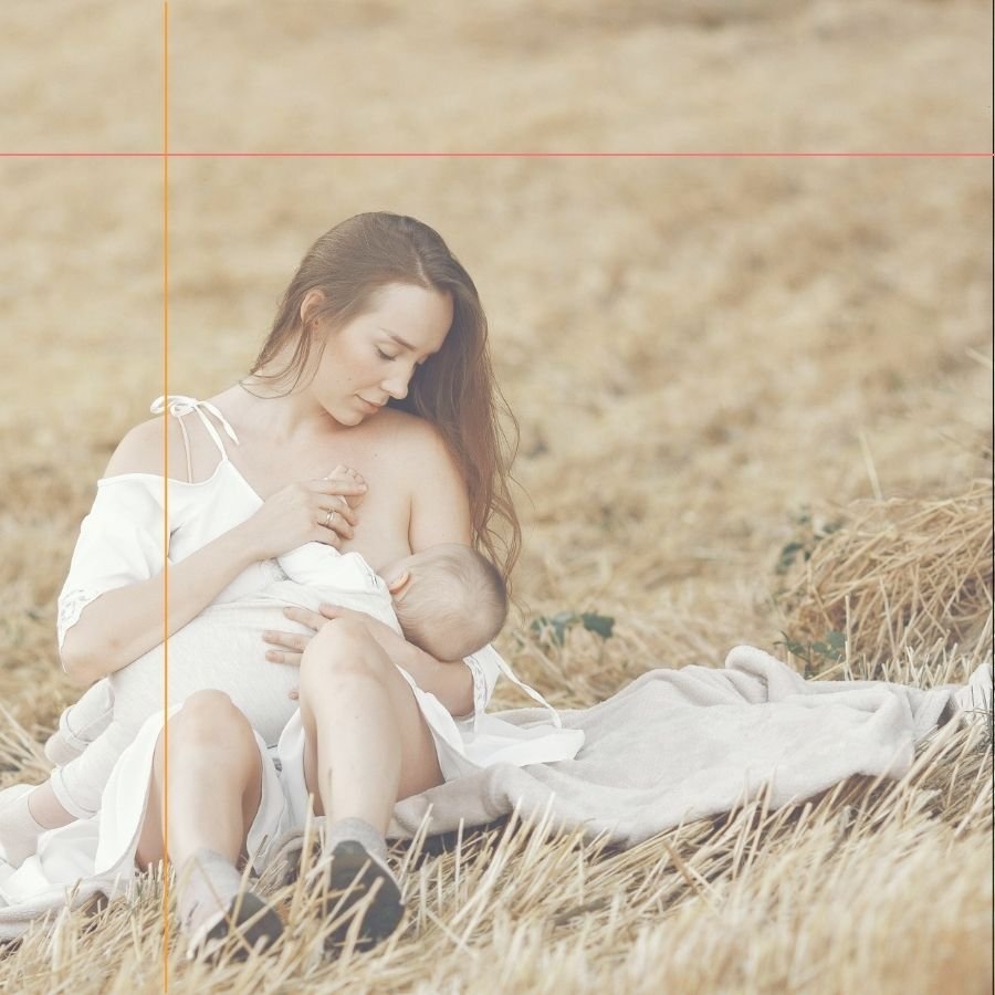 mother breastfeeding her baby outdoors illustrating the importance of breastfeeding and the bond between mom and baby